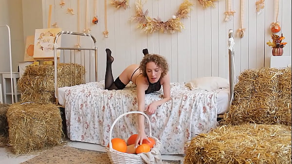 Image Red-haired curly in black stockings on the Halloween kitchen