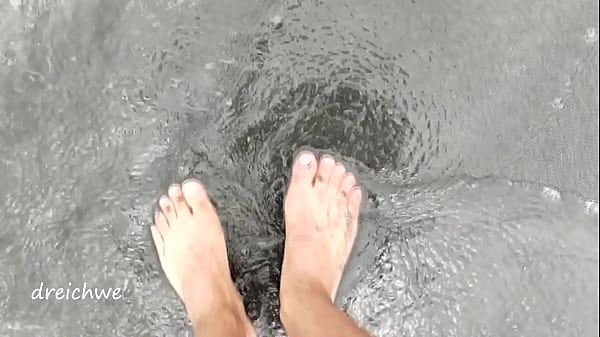 Image foot fetish on the beach with sand