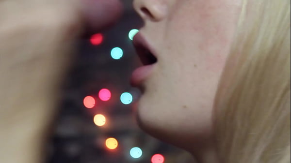 Image Blowjob close-up - against the background of romantic lights and a mouthful of cum
