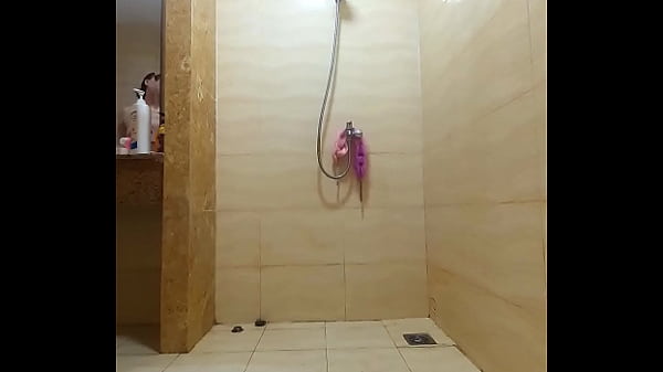 Image Shower. Voyeur camera. Nude Regina Noir in the shower washes and rubs with oil. Vert