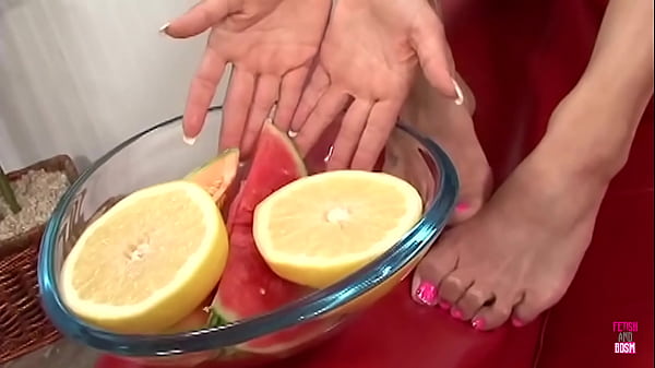 Image A brunette floozy plays with food on her feet and fuck a foot fetish dude