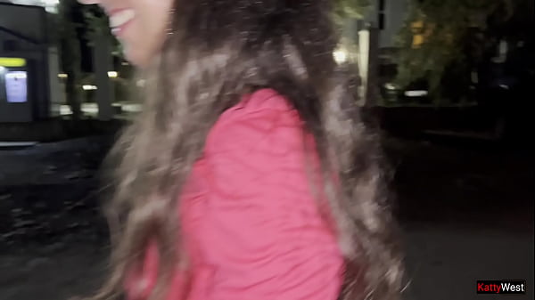 Image Two girlfriends pee together near a car in a public parking lot