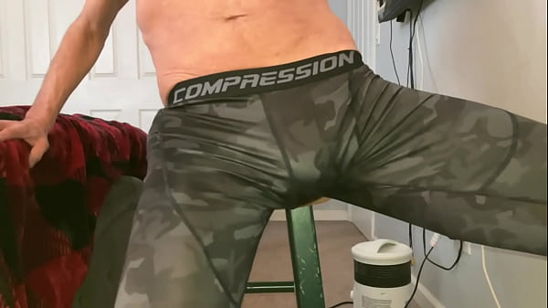 Image Stretching groin with Massage Balls on Stool in Compression Pants