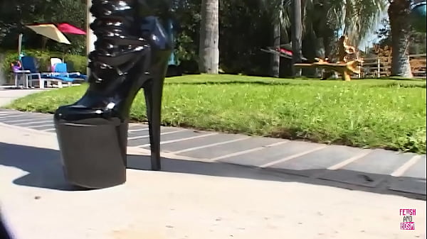 Image A brunette in black leather outfit gets double penetrated by handsome guys in the garden