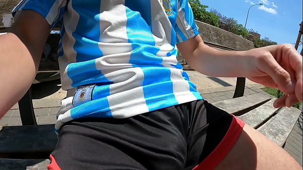 Image Bulging young man moans with pleasure in a public park jerking off in summer