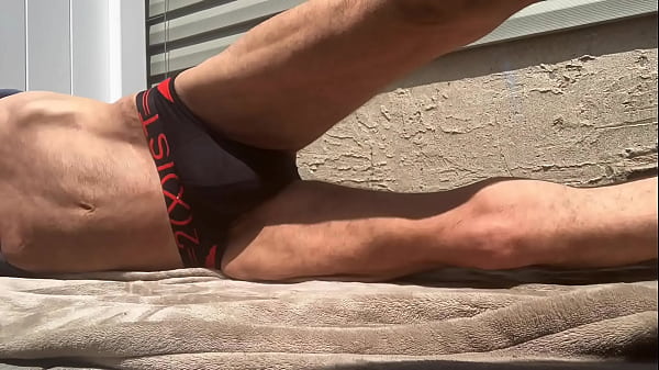 Image Stop Action Core Stretching on Patio in Black and Red Briefs
