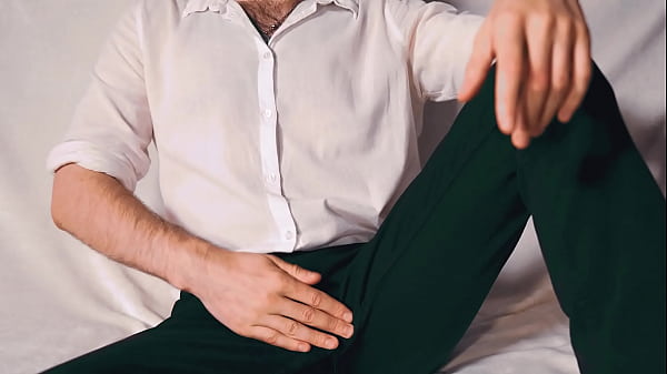Image Handsome Noel Dero watches porn and caresses his dick in a condom close-up.