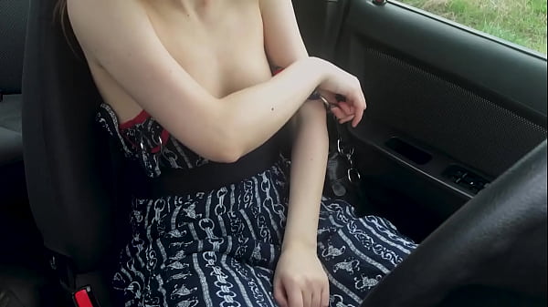 Image A beauty in a dress caresses herself with dilo in the car and cums
