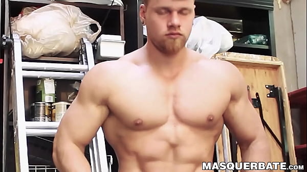 Image Handsome pierced hunk plays with his cock in his storage room