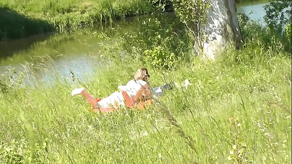 Image Milf sexy woman sunbathing naked on river bank. Random guy is watching. Naked in public. Public. Publicly. Wild beach Nudist. Perfect ass. Pussy. Blonde. Doggystyle. Woman got into doggy style position. Outdoor. Outside. Outdoors. Nudists. Naturist. POV