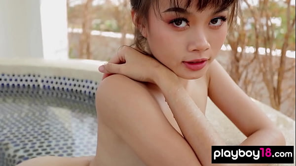 Image Cute faced Thai teen Sowan reveals her exotic pussy on the roof outdoor