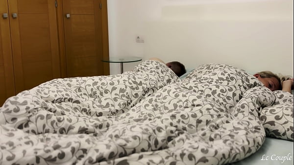 Image Amateur horny girlfriend sneaks into swinger couple bed, where she started to suck a dick and then ride with it - FFM threesome