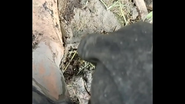 Image Solo Male Wading Barefoot in Lakebed of Mud