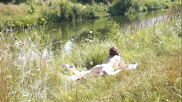 Image Nude Milf sunbathing on river bank. Random guy watching and filmed on his smartphone. Wild beach. Naked in public. Nudist beach. Doggystyle. Ass. Pussy. Doggy style. POV. Outdoor. Outside. Publicly. Ass milf. Butt. In nature. Without panties. No panties