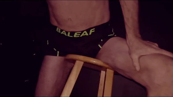 Image Grinding Up Close On Stool in Bicycle Shorts with Dark Background