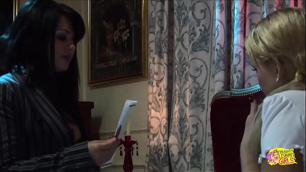 Image Brunette femdom uses her strapon to teach the busty blonde how to please and obey