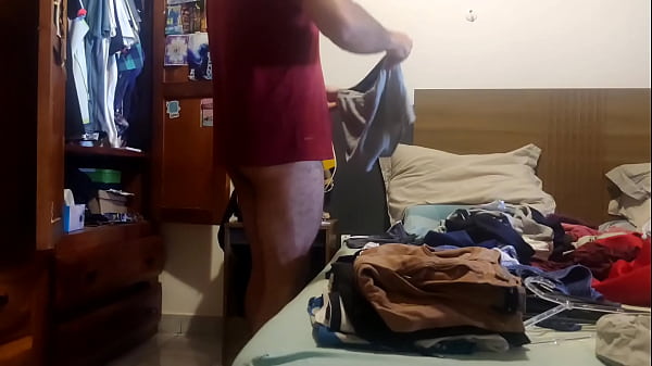 Image I'm folding and putting away my clean clothes, doing it without my pants on, hoping someone catches me leaning against the bed.