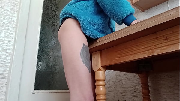 Image Skinny brunette rubs her pussy on the table in the kitchen