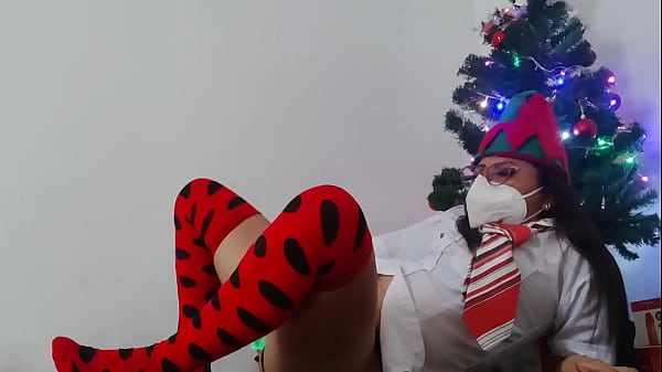 Image Stepmother welcomes Christmas in a very sexy way!! She is under the Christmas tree and masturbates with a dildo with Christmas lights
