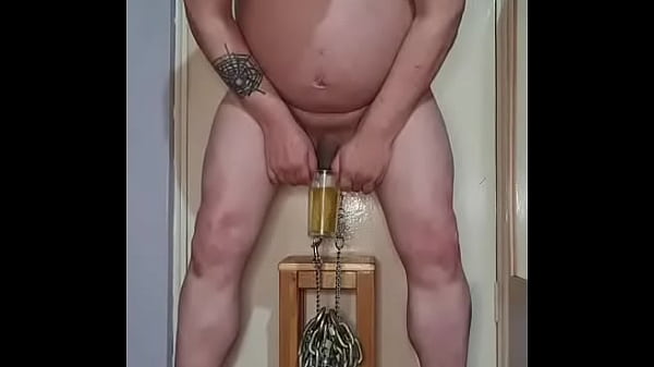 Image hanging heavy chains from my bullsacks with nipple clamps while taking a pee part 1