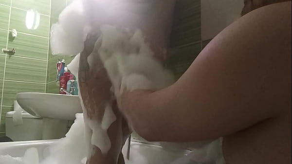 Image Couple take a bath and he touch her busty body
