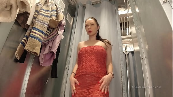 Image I try on clothes in fitting room with open curtain.