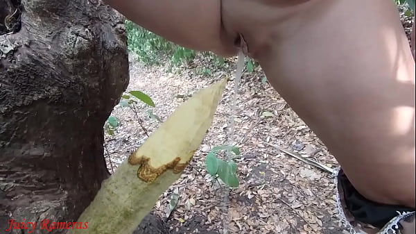 Image Perverted slut squirts piss from wooden stake in forest