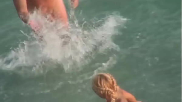 Image Beach Voyeur. Gorgeous blonde babe riding her man on a public beach