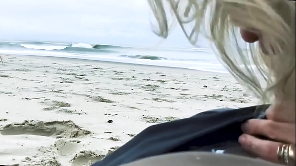 Image Vacationers look on with disapproval as a milf with her BF films anal content right on the beach