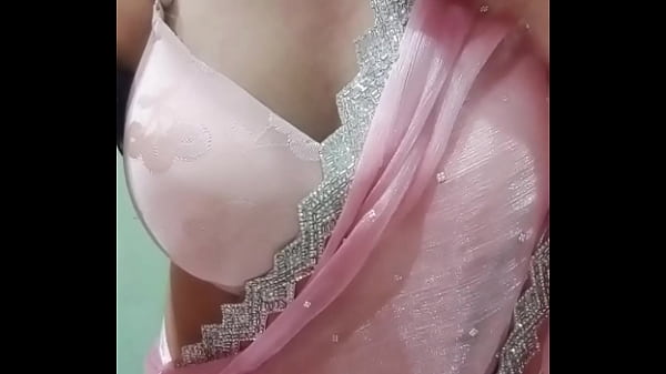 Image Indian Gay Crossdresser Bottom Gaurisissy Pressing and Playing with Her Big Boobs in Pink Saree with jwellery Looking Like a Housewife