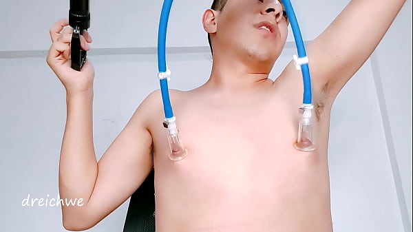 Image sucking my nipples with a pump