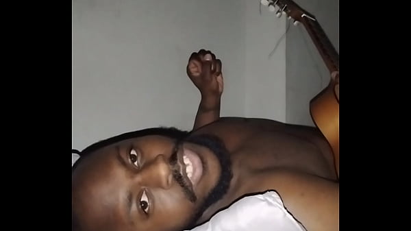 Image Translating other meanings of horns in the air while singing and playing guitar naked