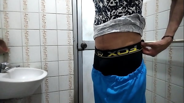 Image Man urinates and masturbates in public bathroom