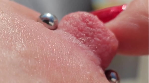 Image Playing Pierced Nipples Close Up on Balcony
