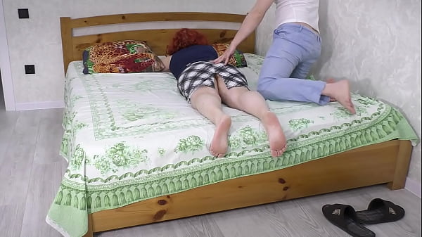 Image The stepmom deliberately lay down on the bed so that her stepson would have sex with her