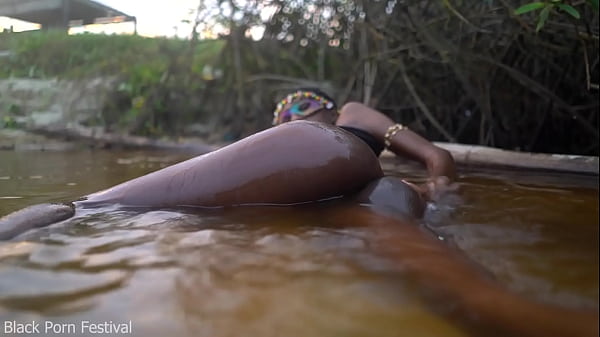 Image Skinny dark skinned African hottie teasing in the water