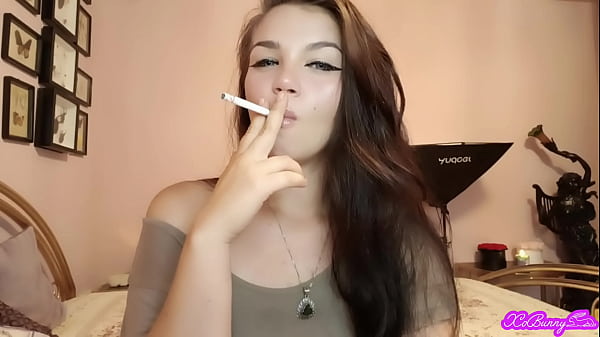 Image XO Bunny brunette latina with blue eyes smoking blowing smokein your face