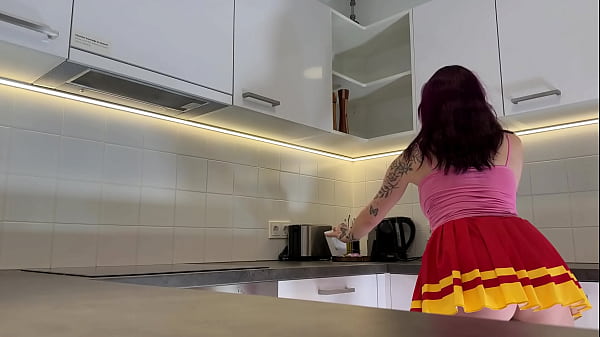 Image Hottest redhead tattooed cheerleader with over knee socks shows her see through panties in the kitchen