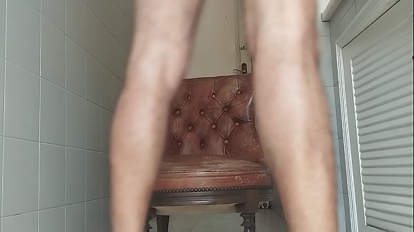 Image Guy of big dick takes armchair to bathroom and masturbates