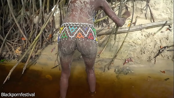 Image Indigeneous naked woman making a camp fire