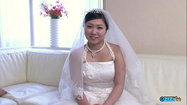 Image The new asian wife is still dressed in her wedding gown when someone visited her