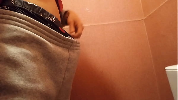 Image What will this cute skinny twink with a big hard cock do, caught between the urgent need to pee and jerk off ?