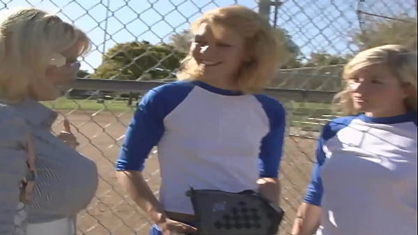 Image The two blonde teens are sitting on the couch with their soccer coach, who happens to be a...