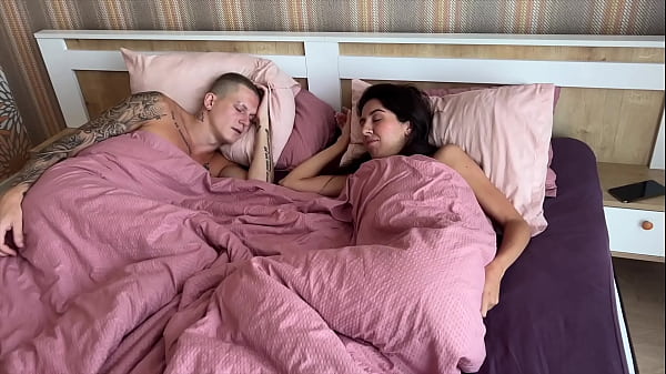 Image A cuckold woke up to see his unfaithful wife being fucked by two men.