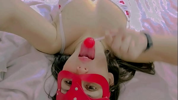 Image Hot and naughty student sucking lollipops at the bed wearing her new white lingerie and touching herself