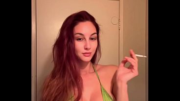 Image Italian Big Tits Milf Artemisia Love showing her juicy tits in a micro bikini while smoking a cigarette